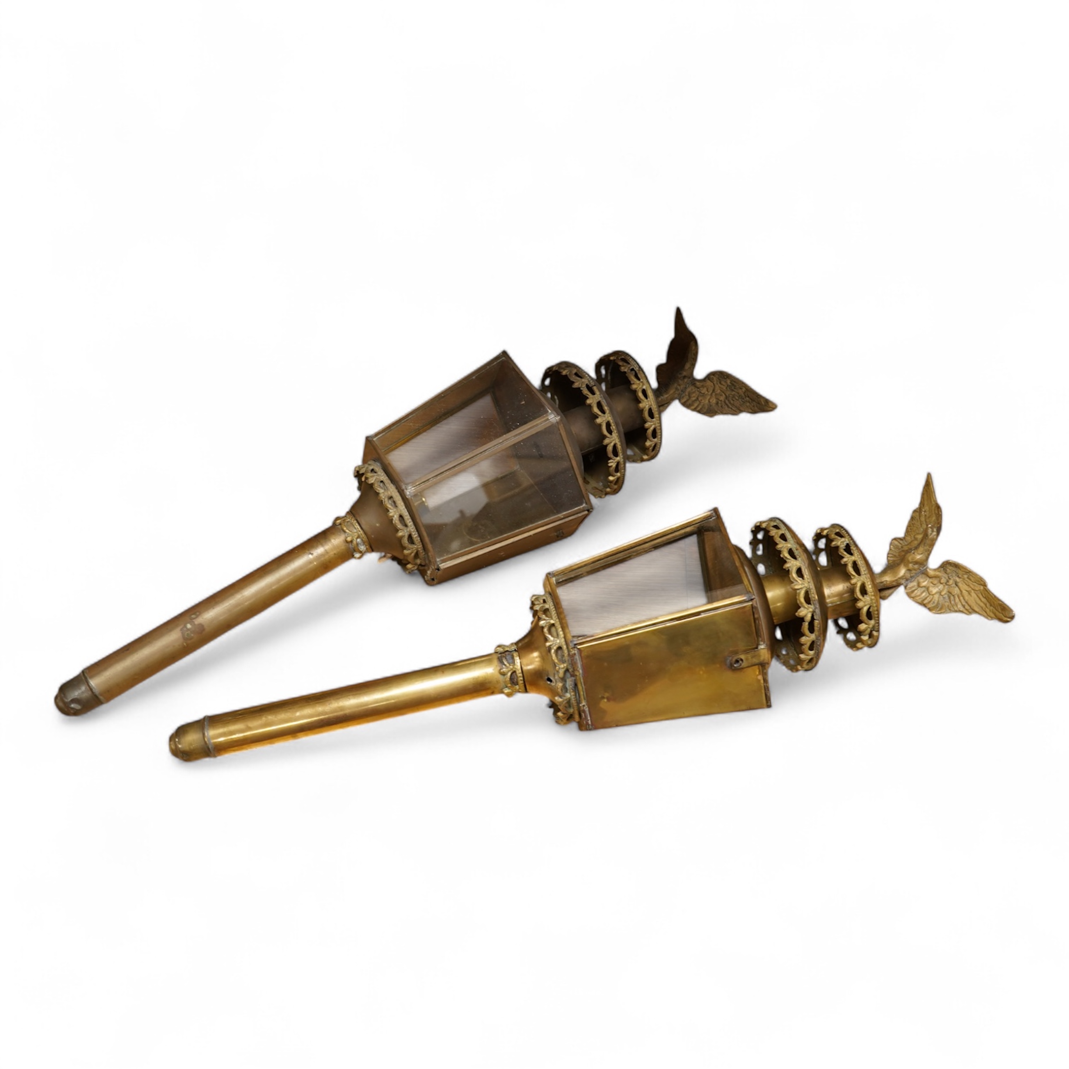 A pair of brass coaching lamps with eagle mounts, 75cm high